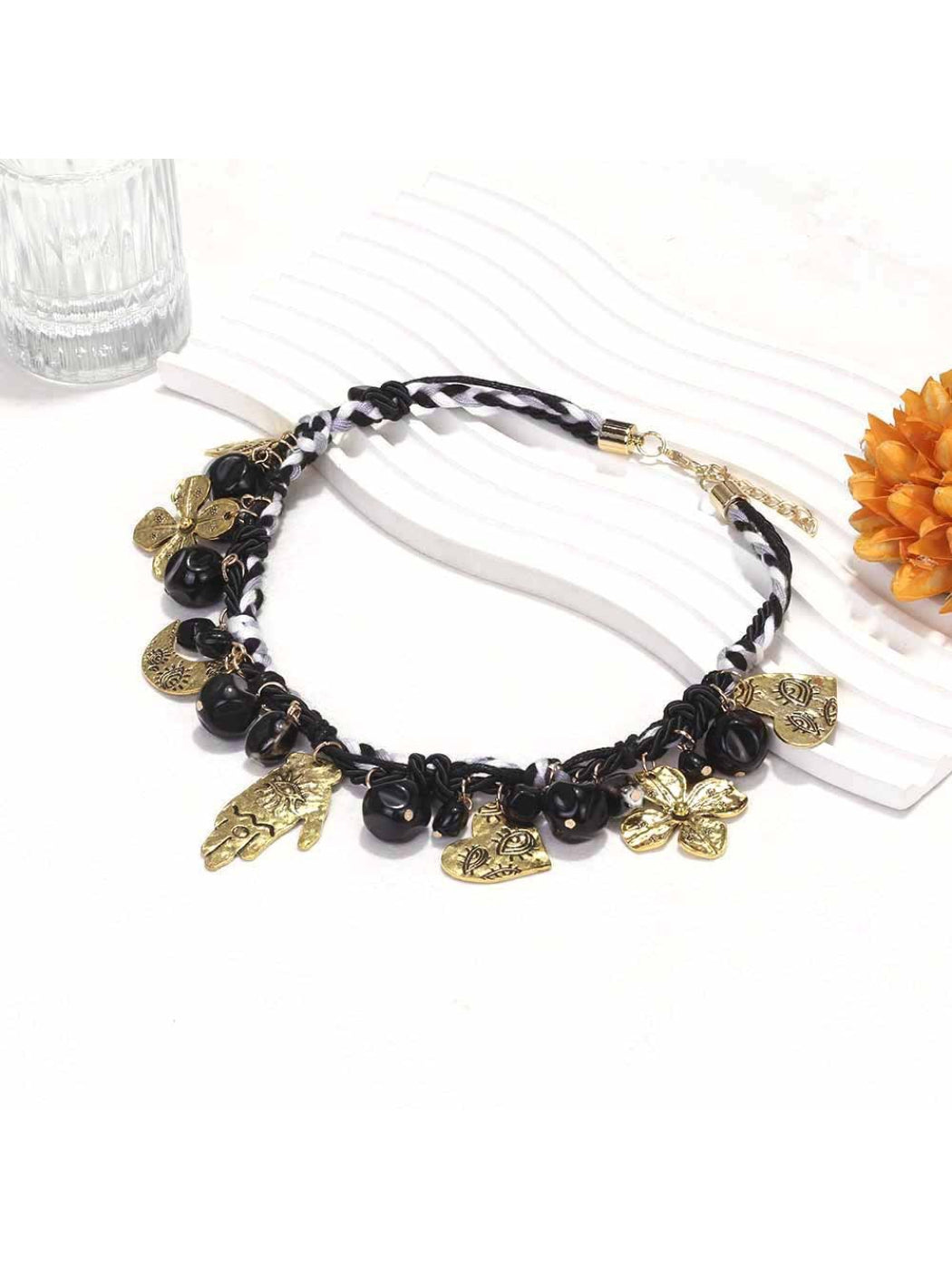 Neckit floral charm necklace displayed coiled on a light background