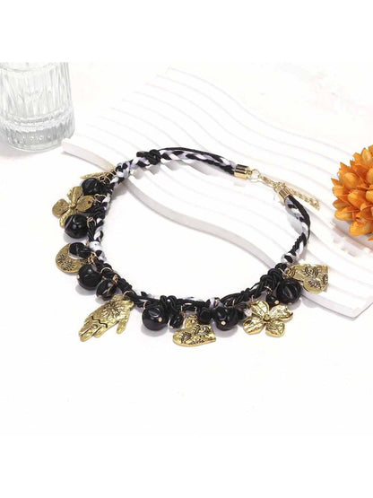 Neckit floral charm necklace displayed coiled on a light background