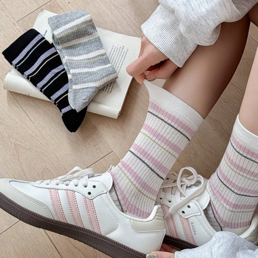 Pair of Rufia ribbed socks with multicolor horizontal stripes on white background