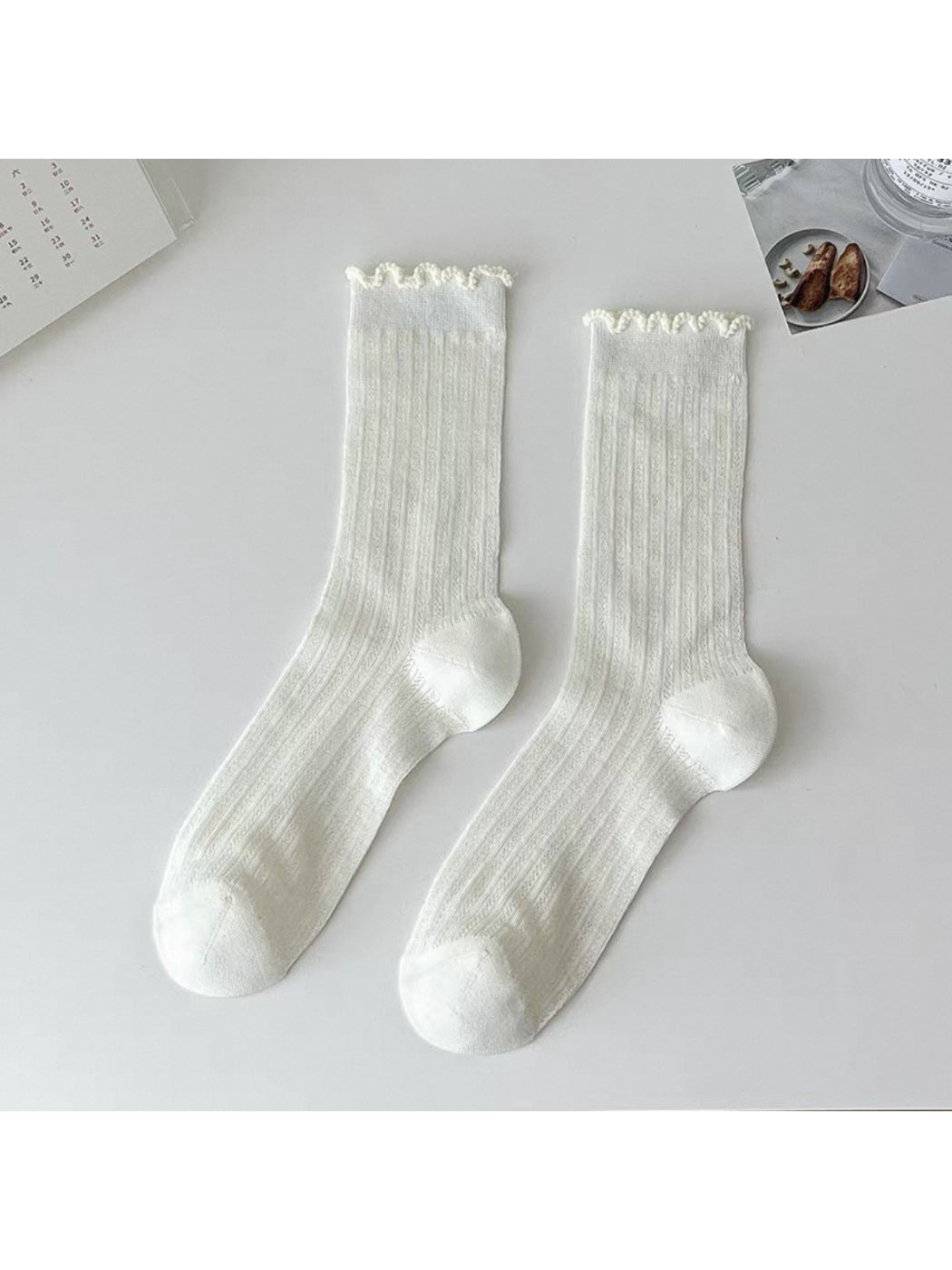 Rufia beige crew socks displayed flat with visible ribbing and ruffle trim