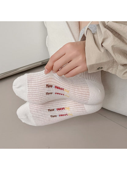 Pair of Rufia vintage stripe accent crew socks in beige and brown tones