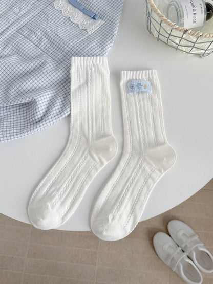 Side view of Rufia Sweet Bear socks highlighting ribbed pattern and bear design