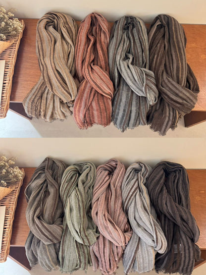 Scarvii textured stripe long scarf shown in natural light on wooden surface