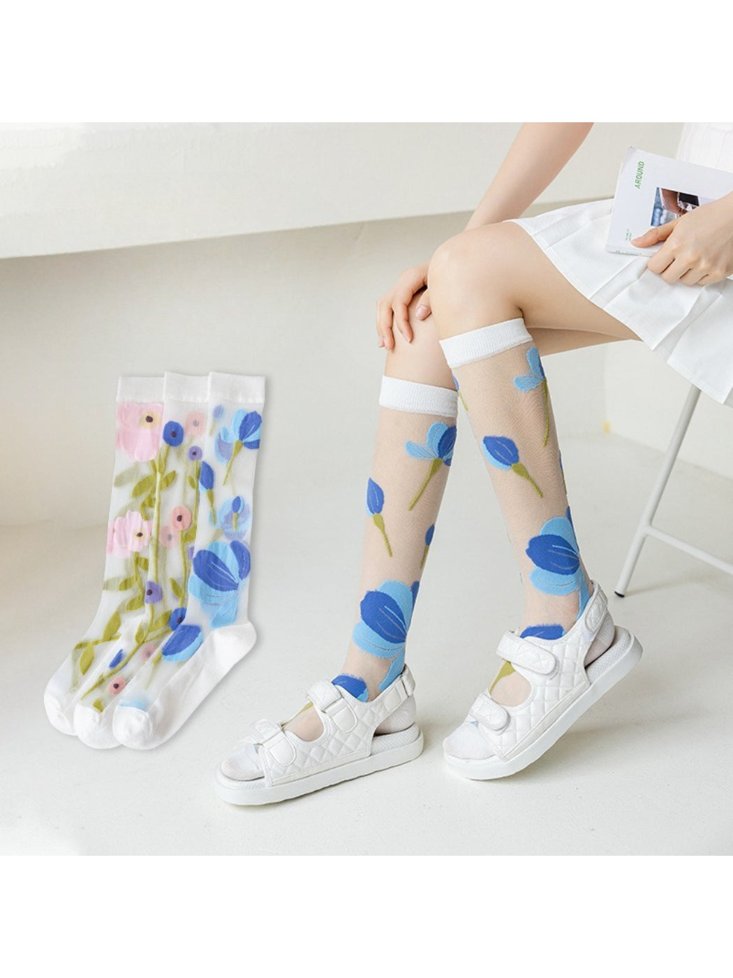 Pair of Rufia Bloom mesh knee high socks in black on a white background