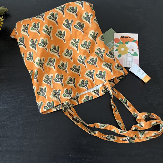 Orange botanical leaf shoulder tote with slim fabric straps