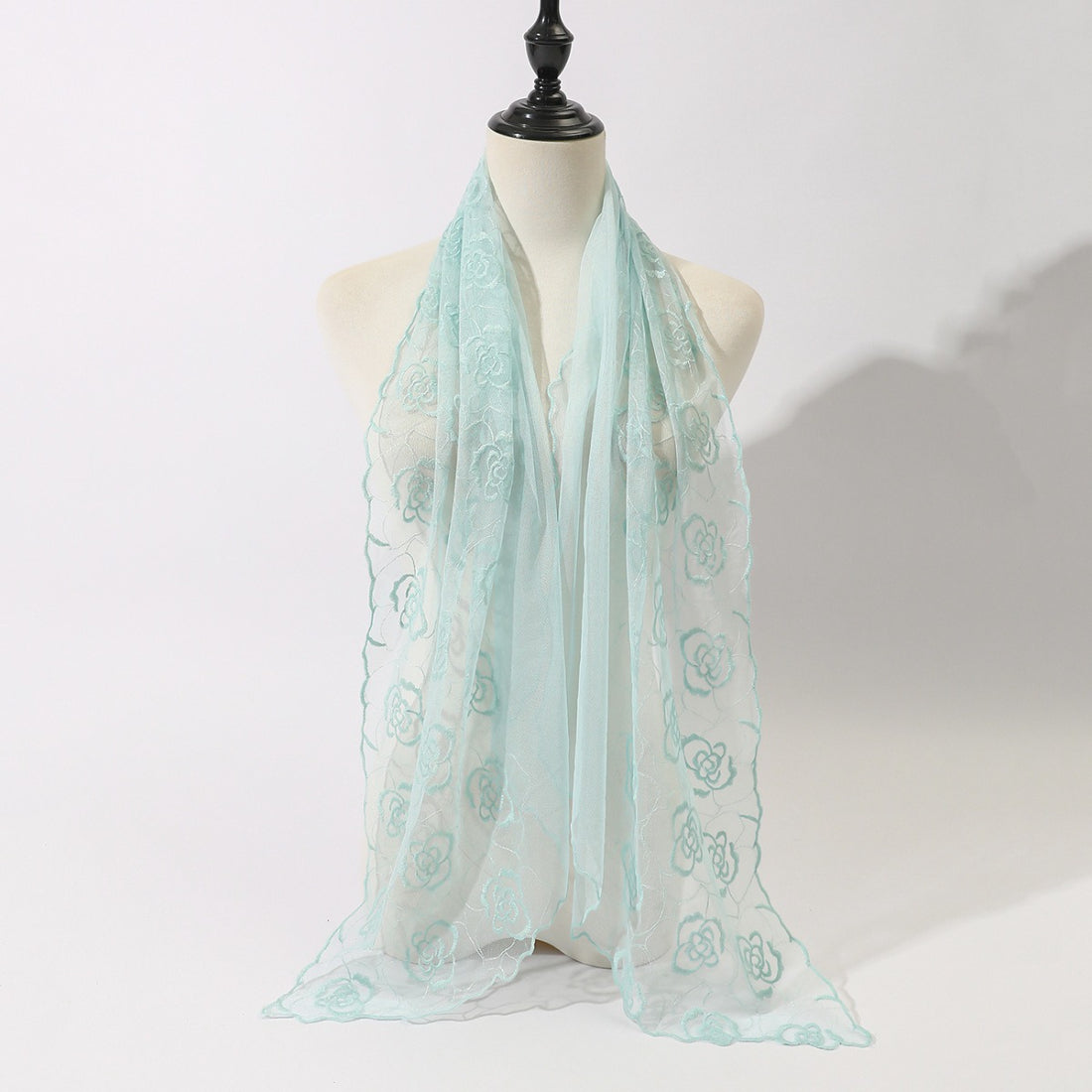 Scarvii floral sketch tulle shawl scarf displayed on a wooden table