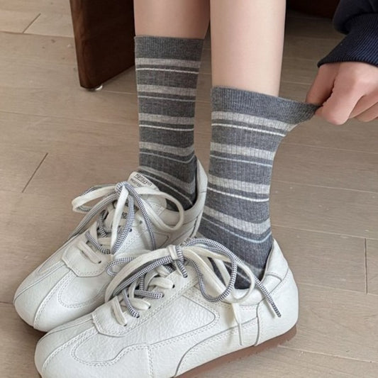 Close-up of Rufia ribbed socks showing colorful stripe pattern and texture