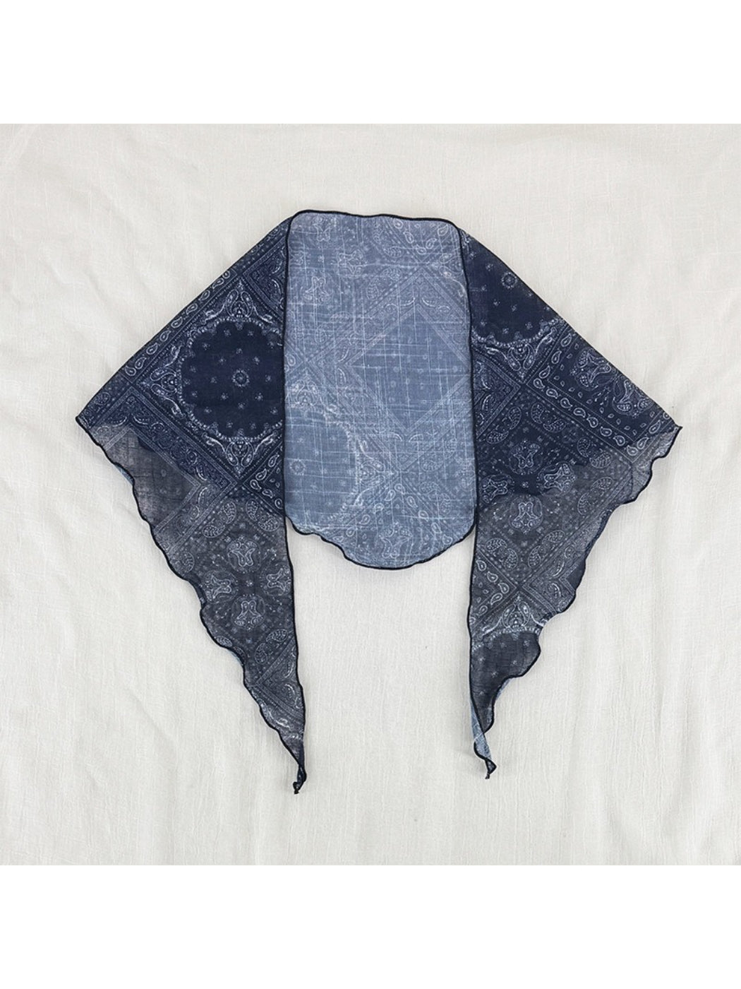Close-up of paisley pattern on soft fabric triangle head scarf