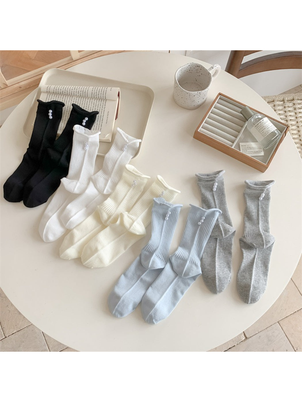 Pair of Rufia simple rib crew socks in light beige with subtle bead detail