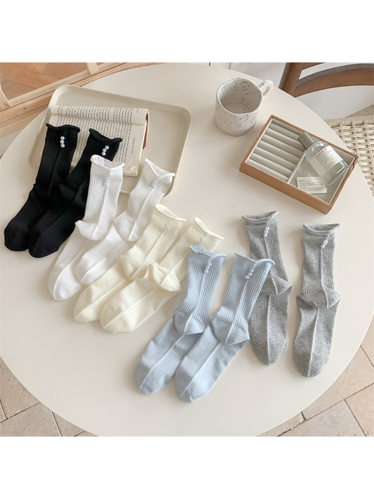 Pair of Rufia simple rib crew socks in light beige with subtle bead detail