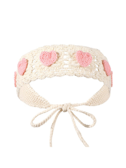 Scarvii crochet heart tie headband displayed flat highlighting crochet texture and heart design