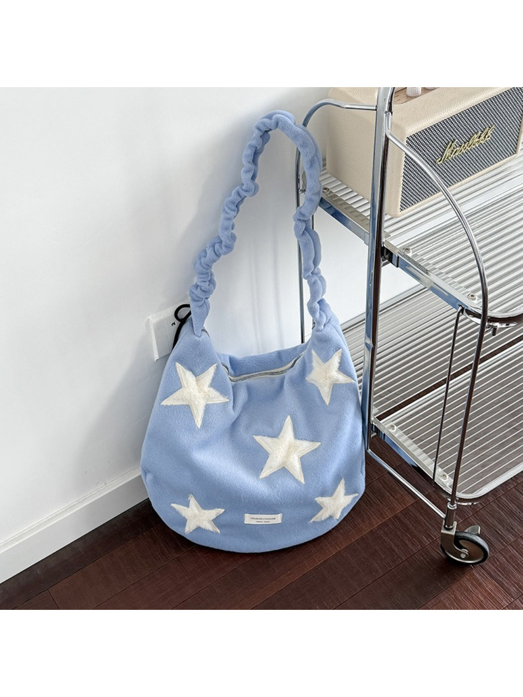 Back view of beige Cosbai slouchy shoulder bag with star patch