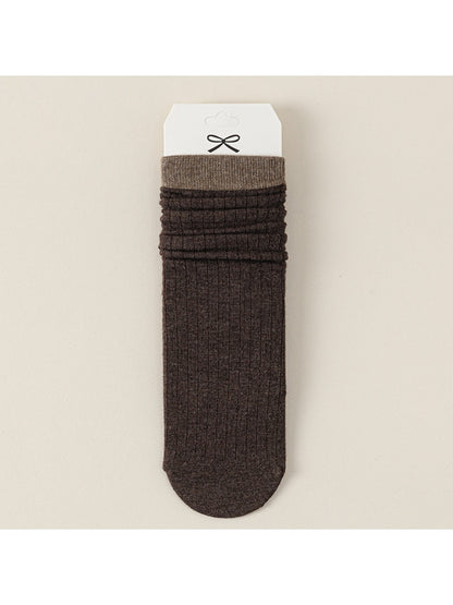Three pairs of Rufia ribbed mid-calf socks in beige, gray, and black arranged side by side