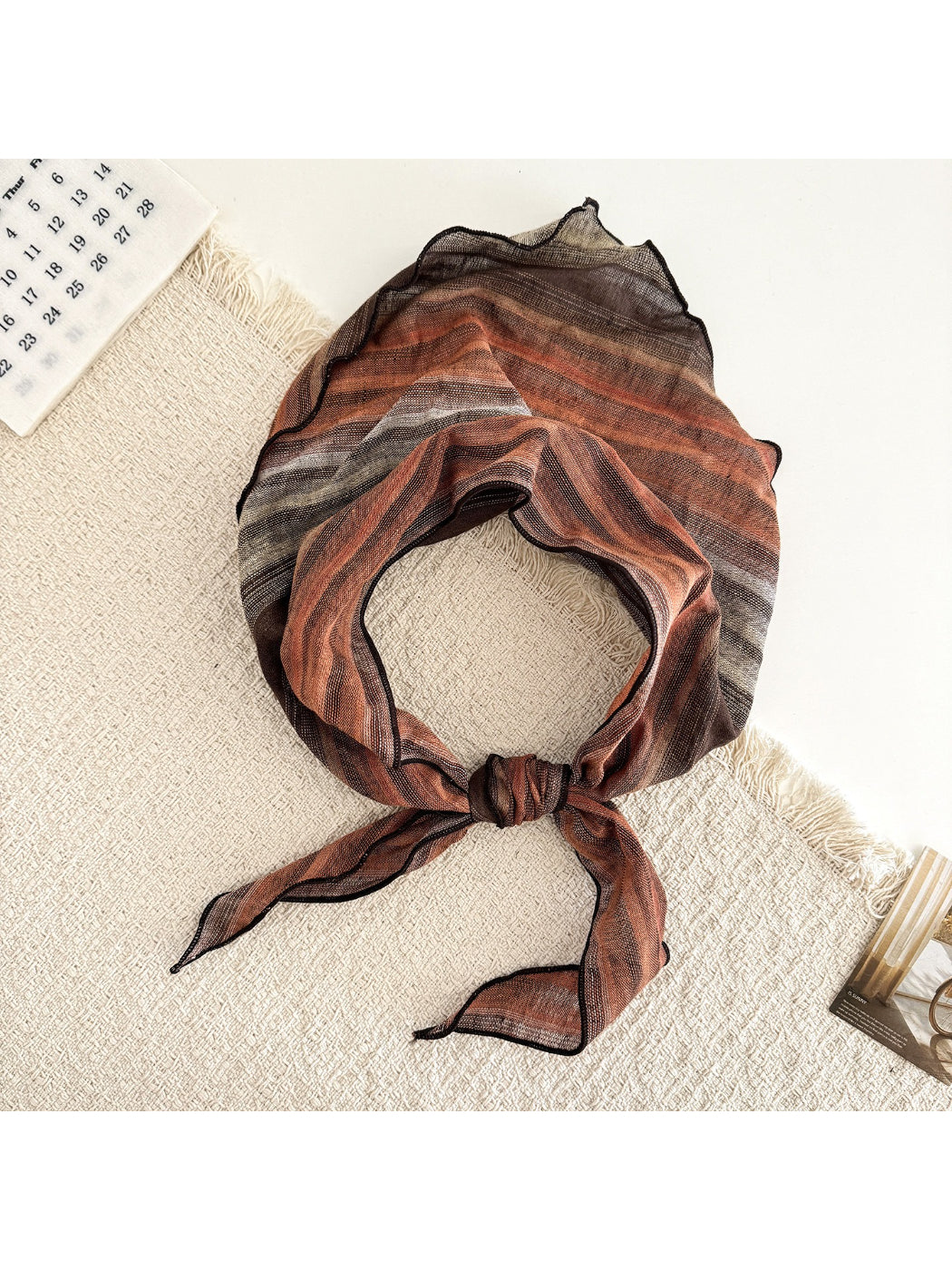 Close-up of sheer fabric with gradient colors on triangle scarf highlighting texture