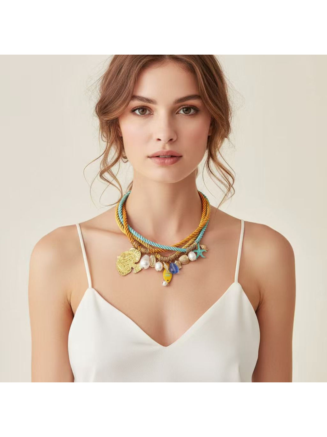 Ocean Charm rope necklace featuring shell details laid flat on a white background