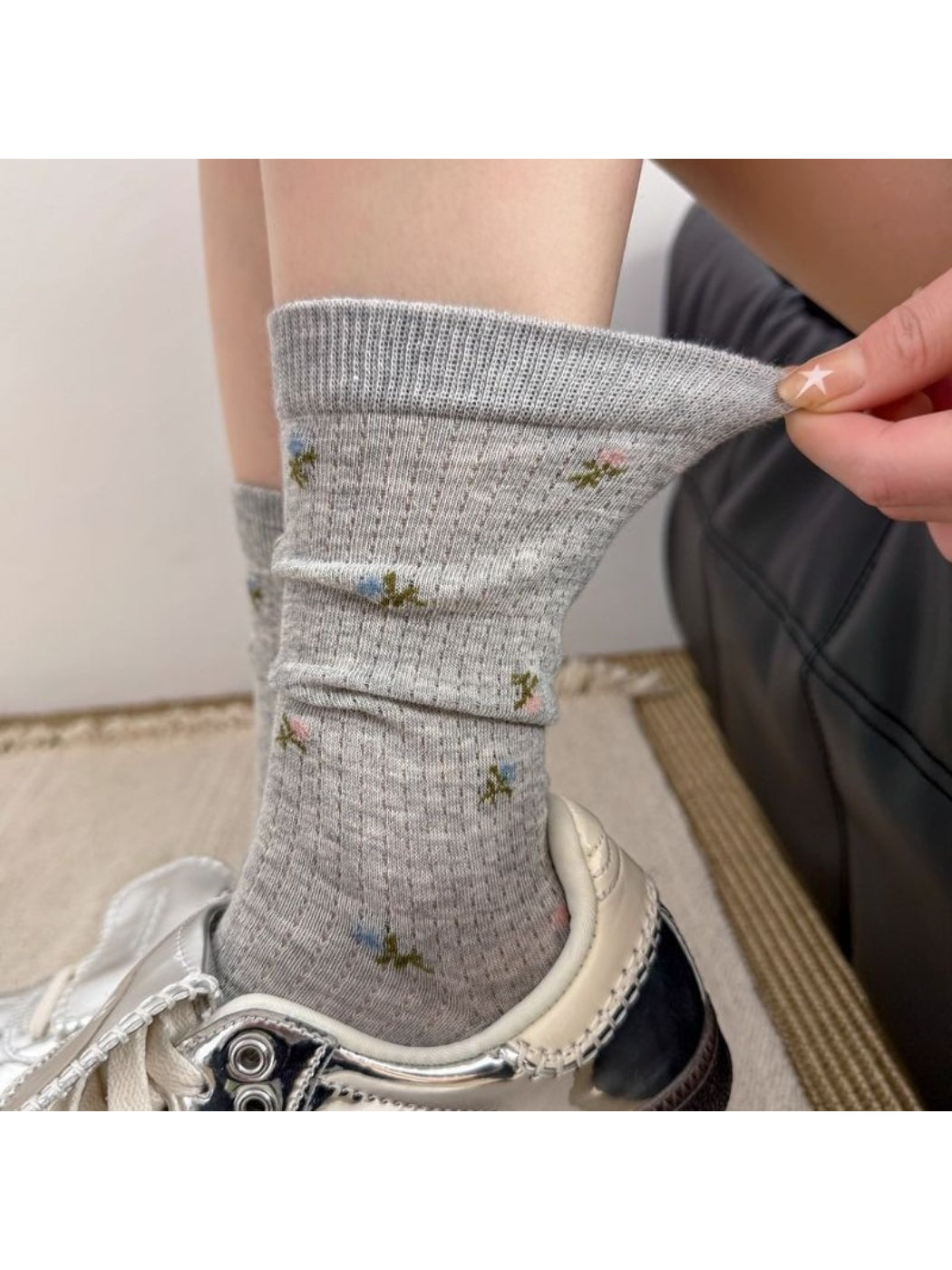 Pair of Rufia soft blossom pattern crew socks in pastel colors displayed flat