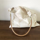 Close-up of ivory hobo bag pattern and stitching details