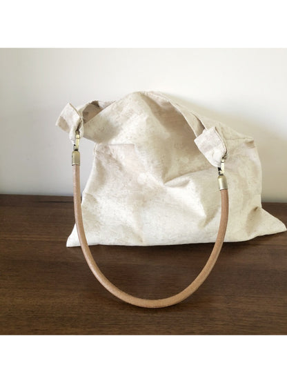 Close-up of ivory hobo bag pattern and stitching details