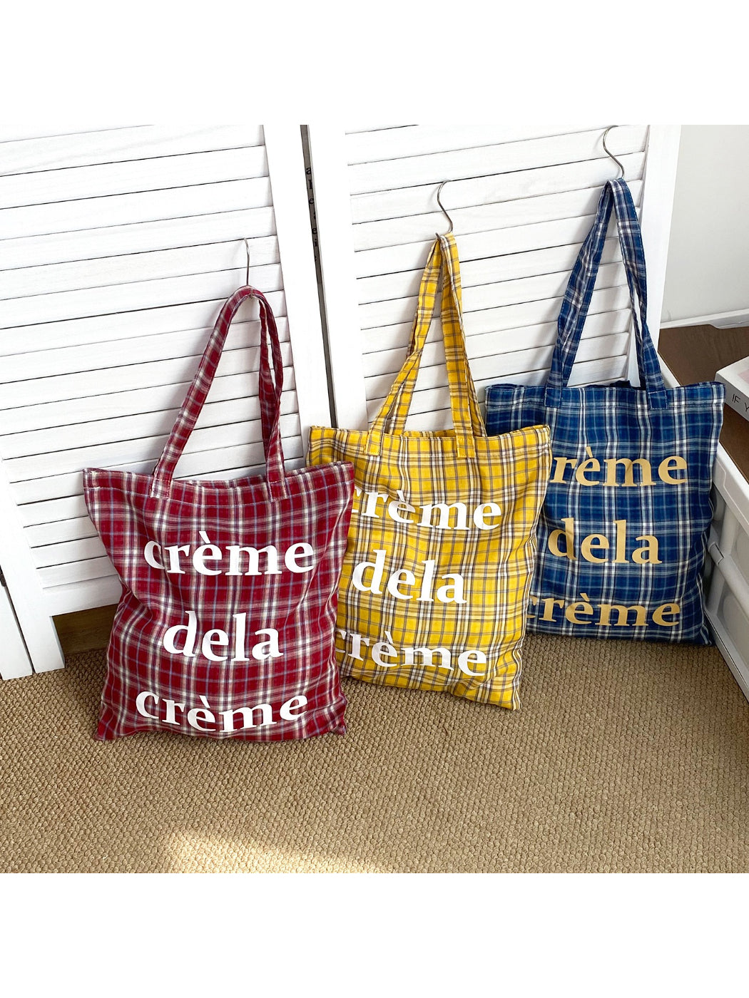 Close-up of letter print detail on Cosbai plaid tote bag