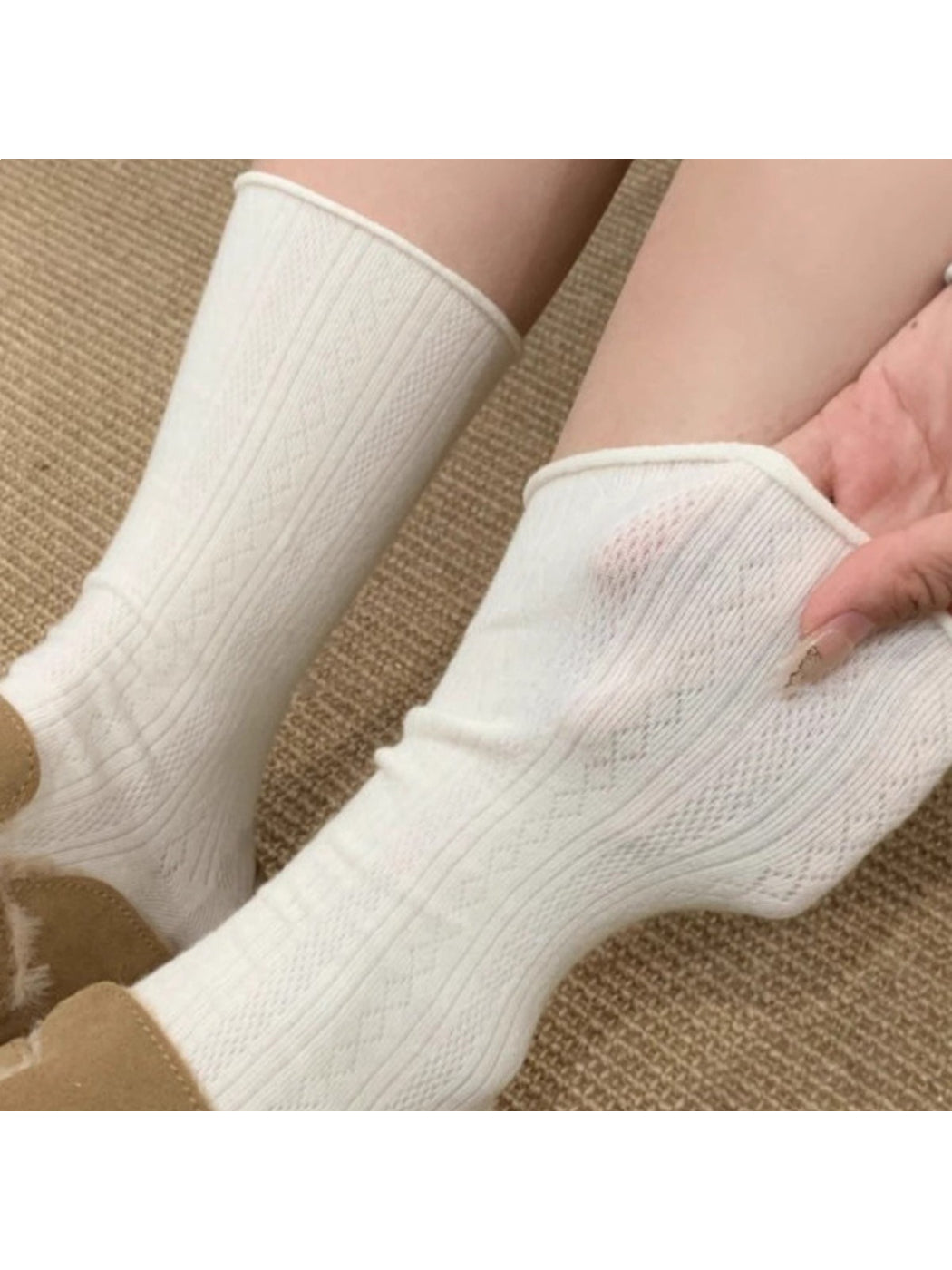 White mid-calf sock displayed upright against a plain background