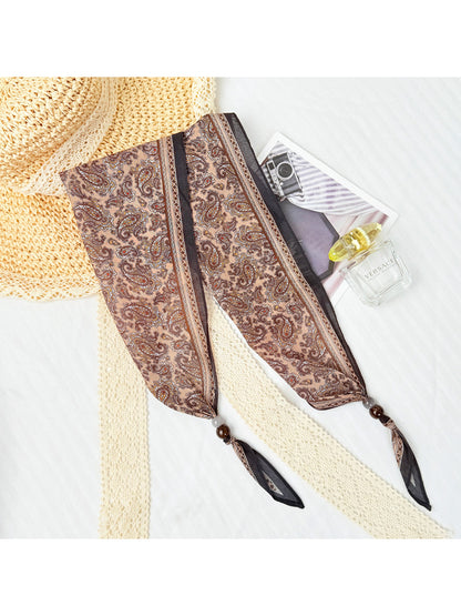 Side view of model wearing Scarvii paisley bead triangle scarf with casual outfit