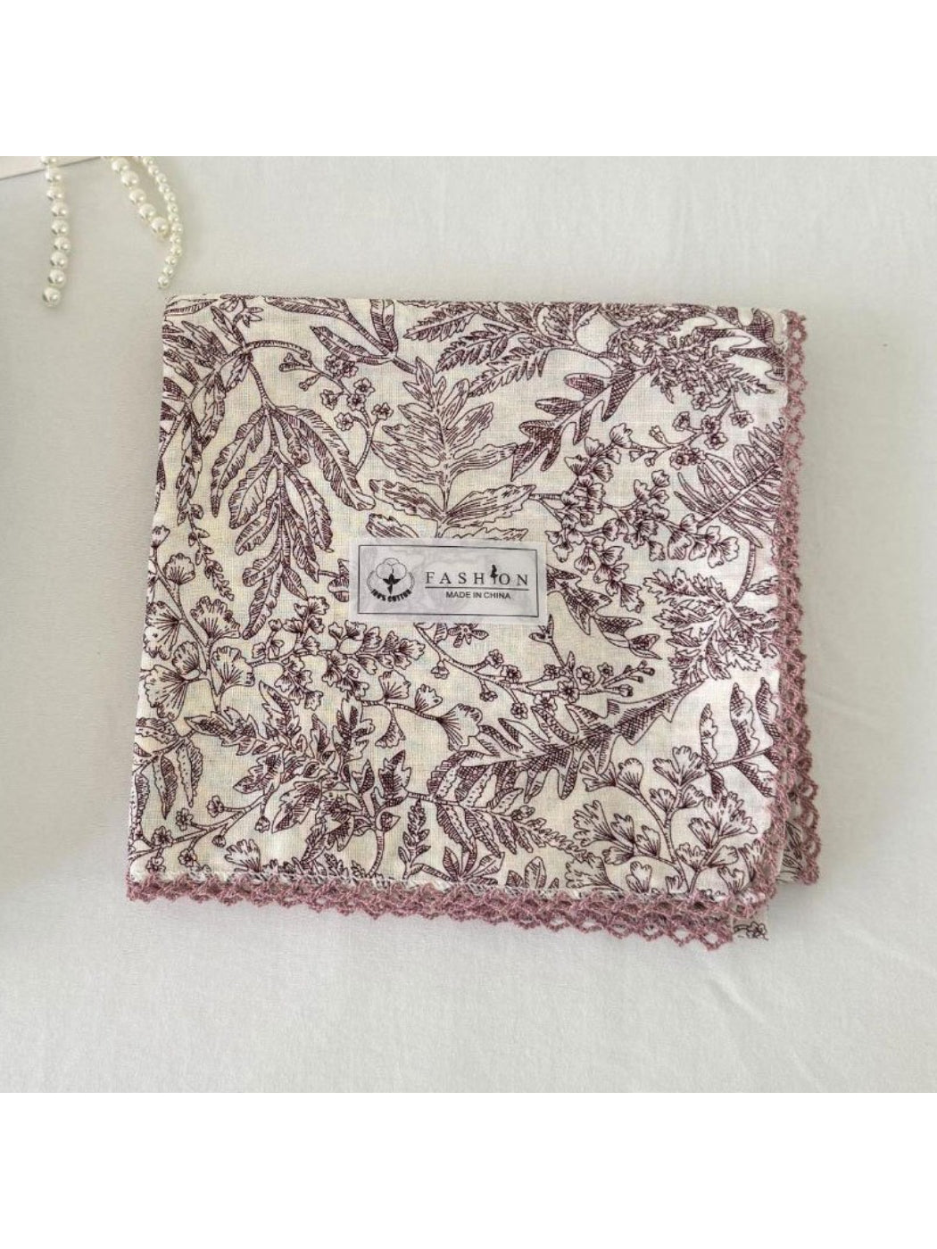Scarvii scarf displayed on white background emphasizing square shape and ornate botanical print