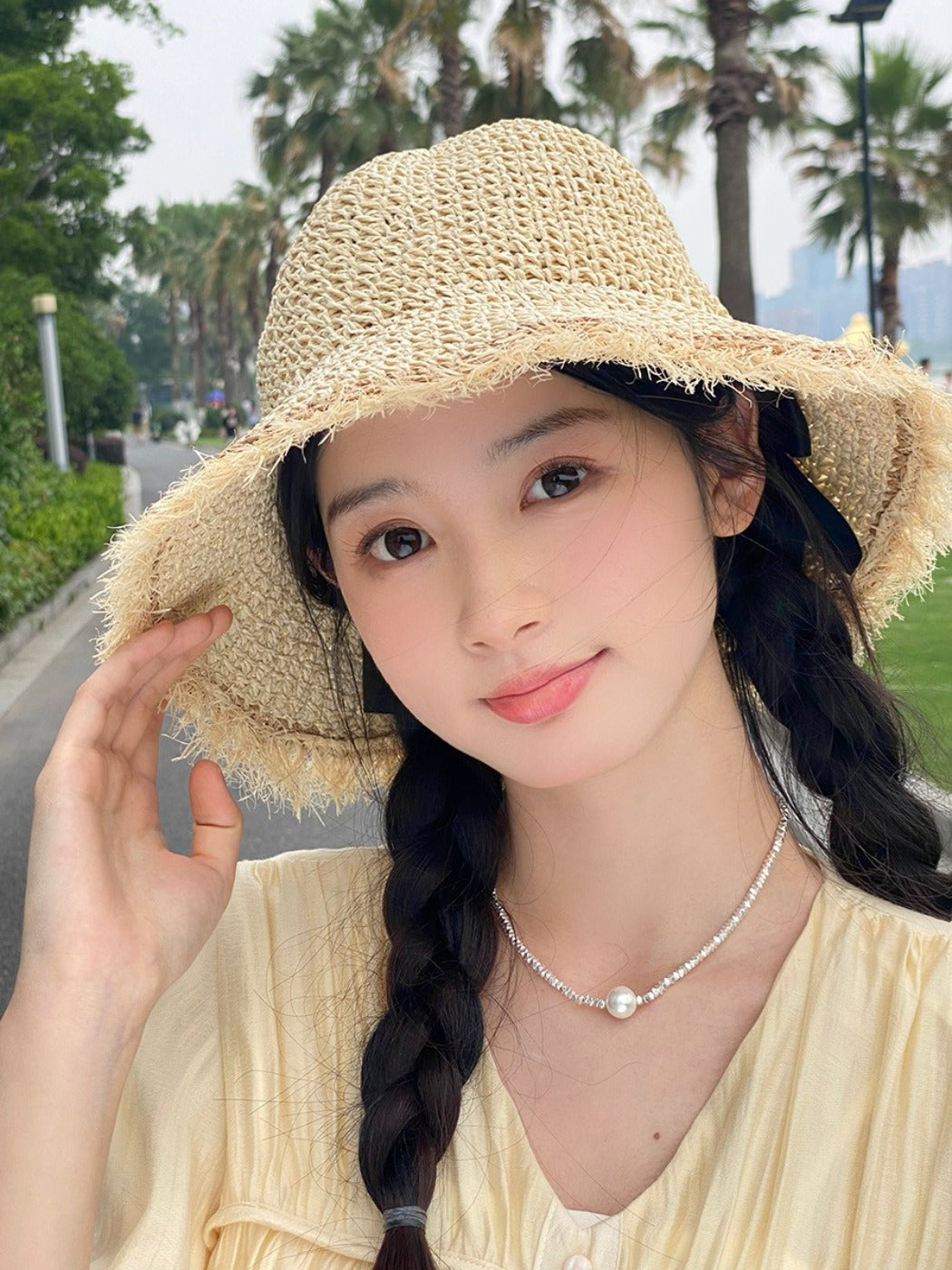 Model wearing Haila beachy textured brim hat outdoors with a casual summer outfit