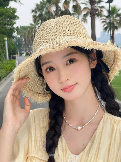 Model wearing Haila beachy textured brim hat outdoors with a casual summer outfit