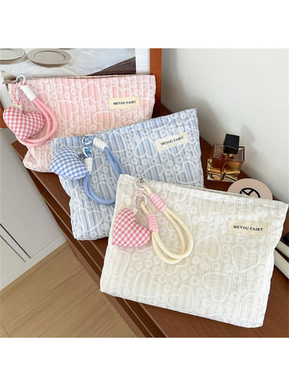 Close-up of Cosbai heart print cosmetic pouch and fabric texture