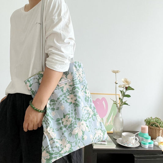 Close-up of Cosbai Soft Bloom tote bag showing floral print and black shoulder strap