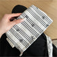 Side view of Cosbai gingham bow makeup pouch in checkered fabric