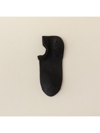 Pair of beige liner socks stacked with one sock slightly lifted