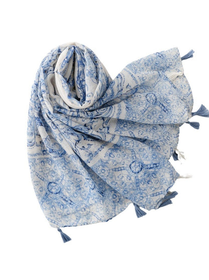 Model wearing blue baroque tassel scarf styled around neck