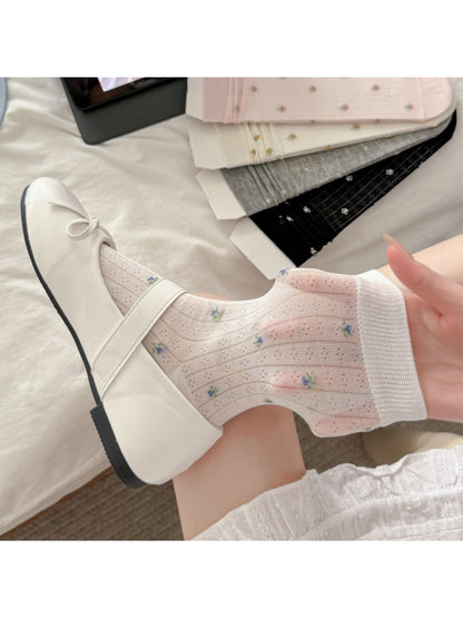 Rufia crew socks worn with casual shoes showing floral design and ribbing