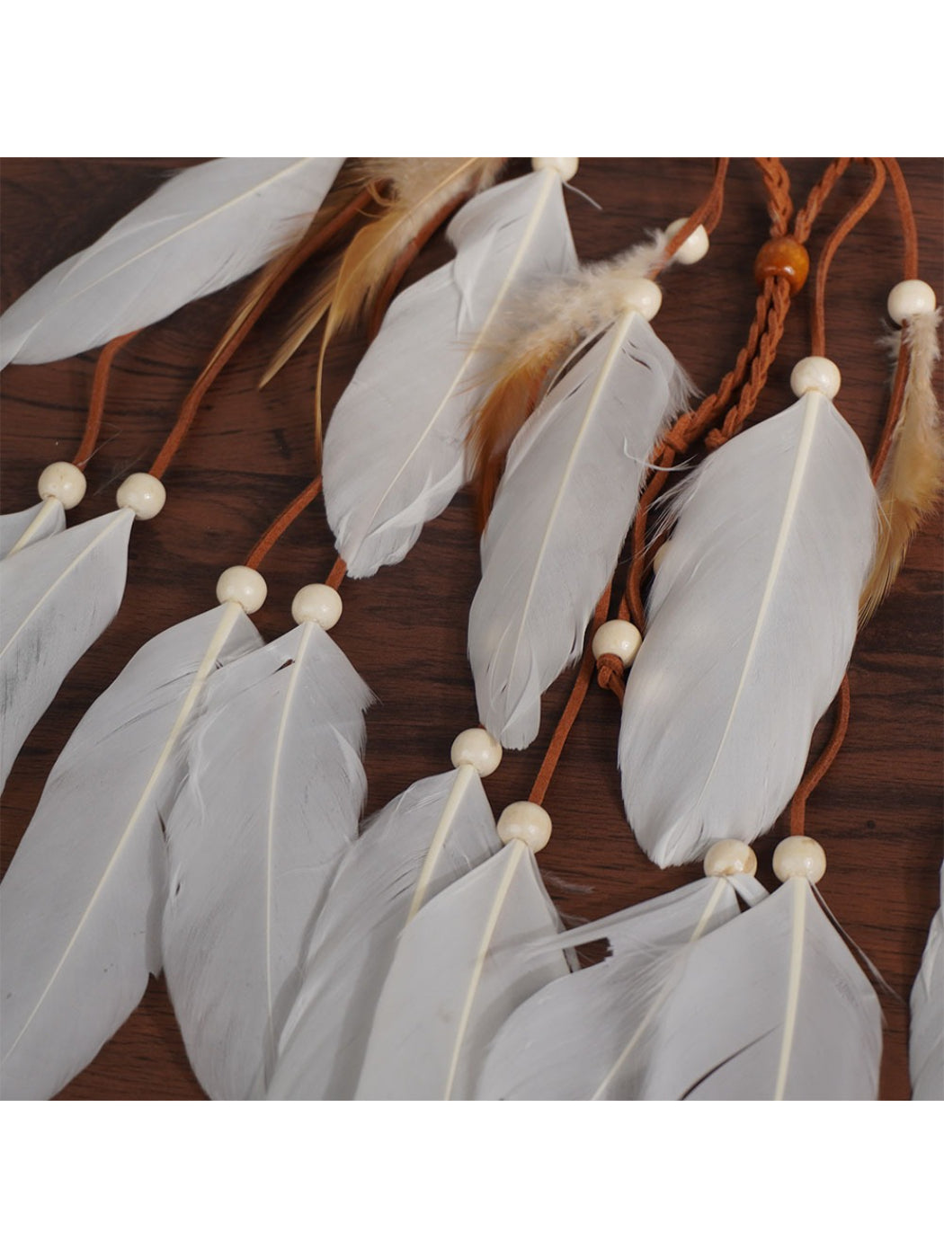 Side view of Hairish Boho multi drop feather hair headpiece with feathers hanging down