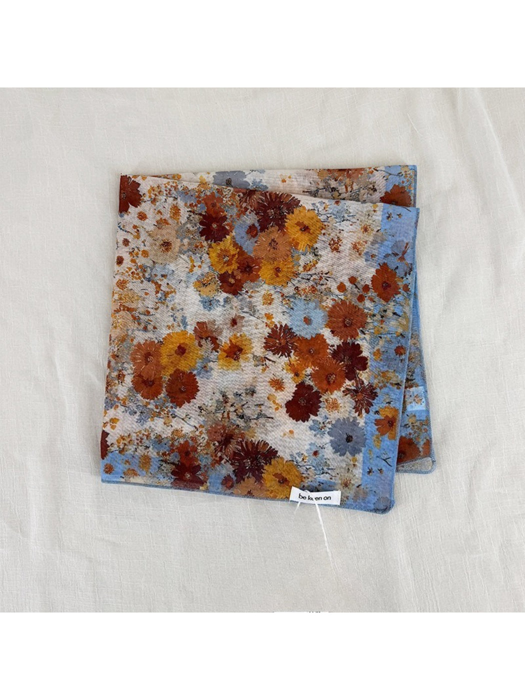 Scarvii vintage floral square scarf folded neatly with visible floral pattern edges