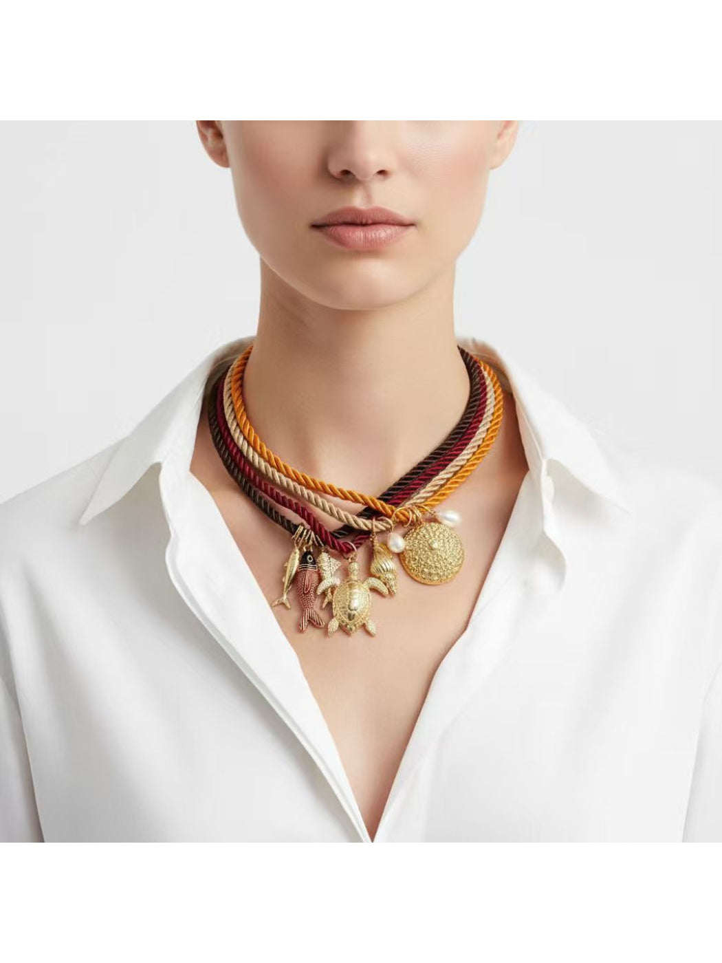 Close-up of Neckit multi strand rope necklace with detailed ocean charms