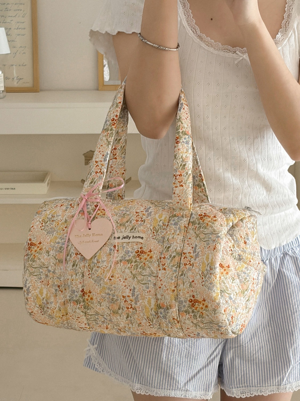 Cosbai Quilted Floral Duffle Bag displayed with adjustable shoulder strap attached