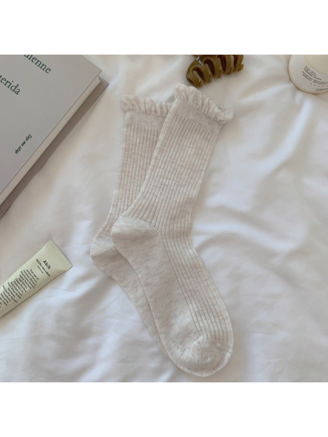 Side view of Rufia white crew socks showing lace trim
