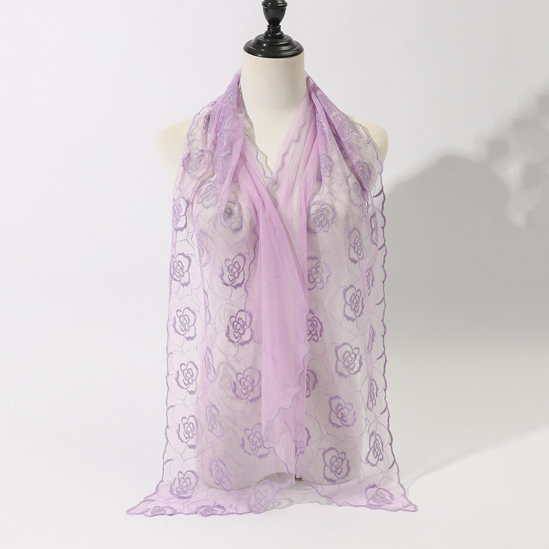 Model wearing Scarvii floral sketch tulle shawl scarf over a white dress