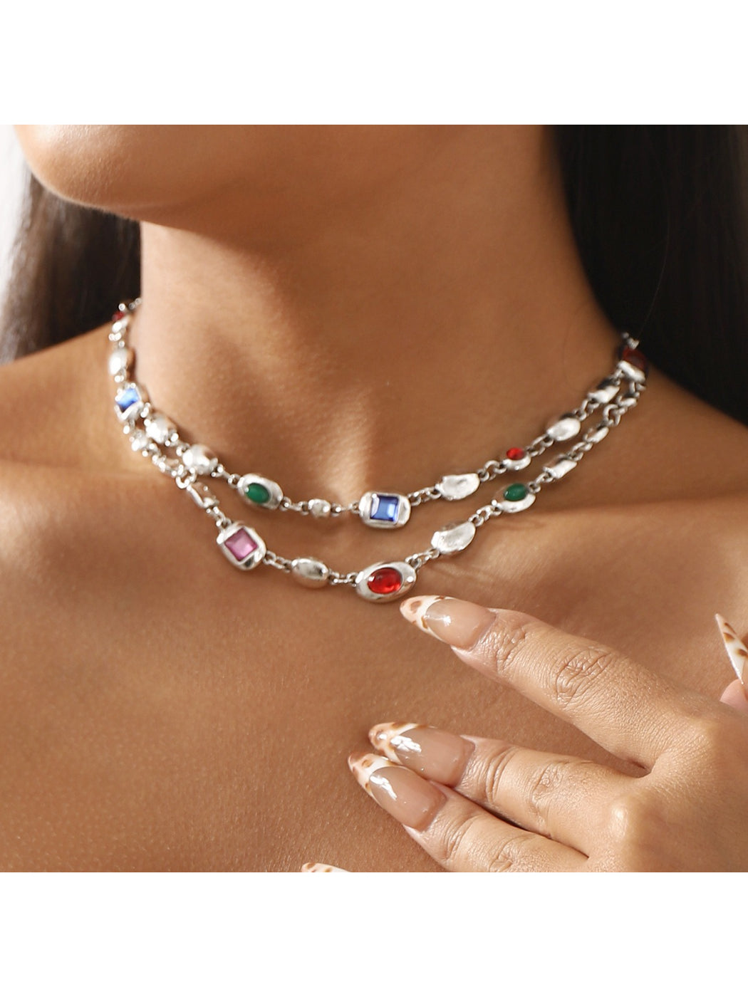 Close-up of Neckit layered gem chain necklace with multiple delicate chains and small gemstone accents