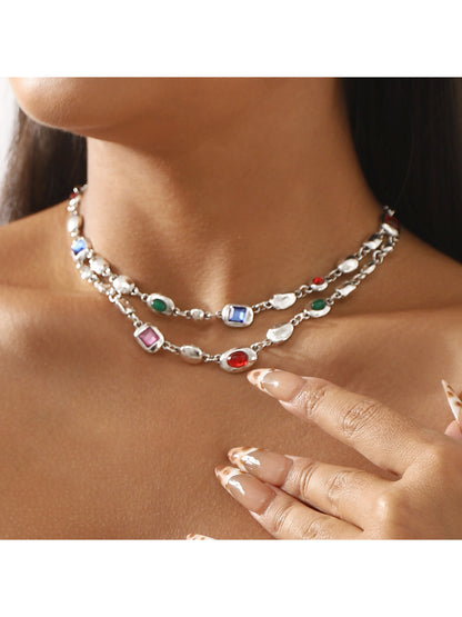 Close-up of Neckit layered gem chain necklace with multiple delicate chains and small gemstone accents