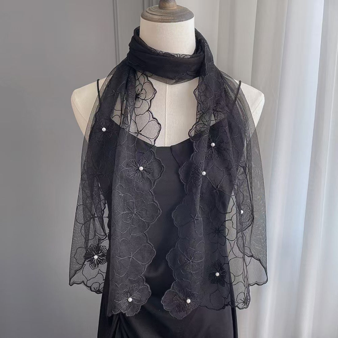 Model wearing Scarvii floral lace pearl trim scarf styled with a white blouse