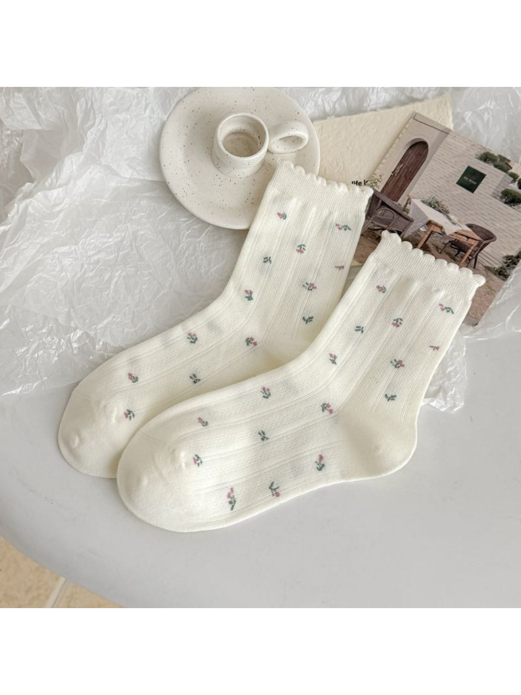 Side view of Rufia lace trim crew socks on model's feet