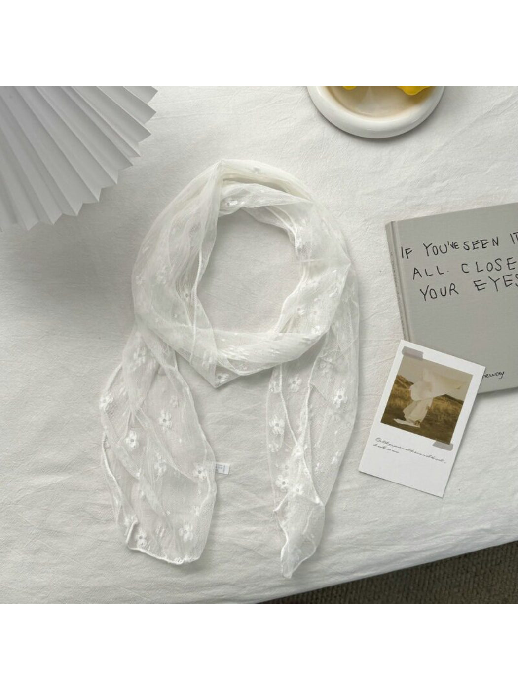 Model wearing Soft Blossom Sheer Scarf styled around the neck with soft pastel colors
