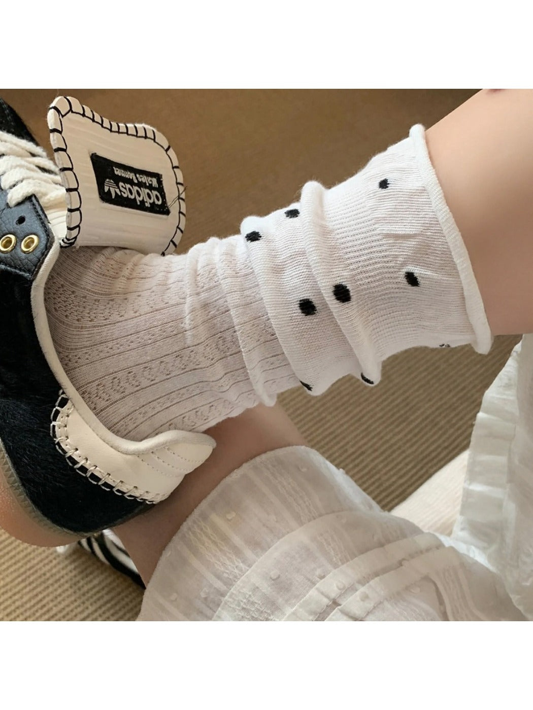 Side view of Rufia mid-calf socks showing ruffle detail and mesh dot texture