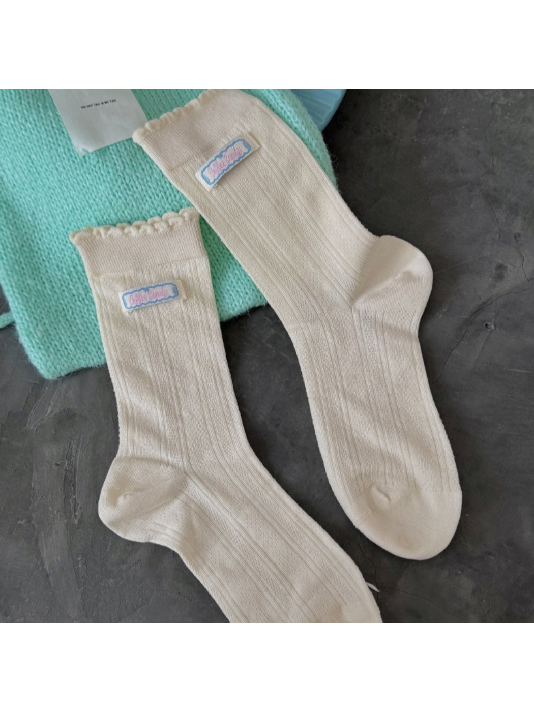 Model wearing Rufia soft scallop trim socks paired with casual shoes