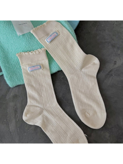 Model wearing Rufia soft scallop trim socks paired with casual shoes