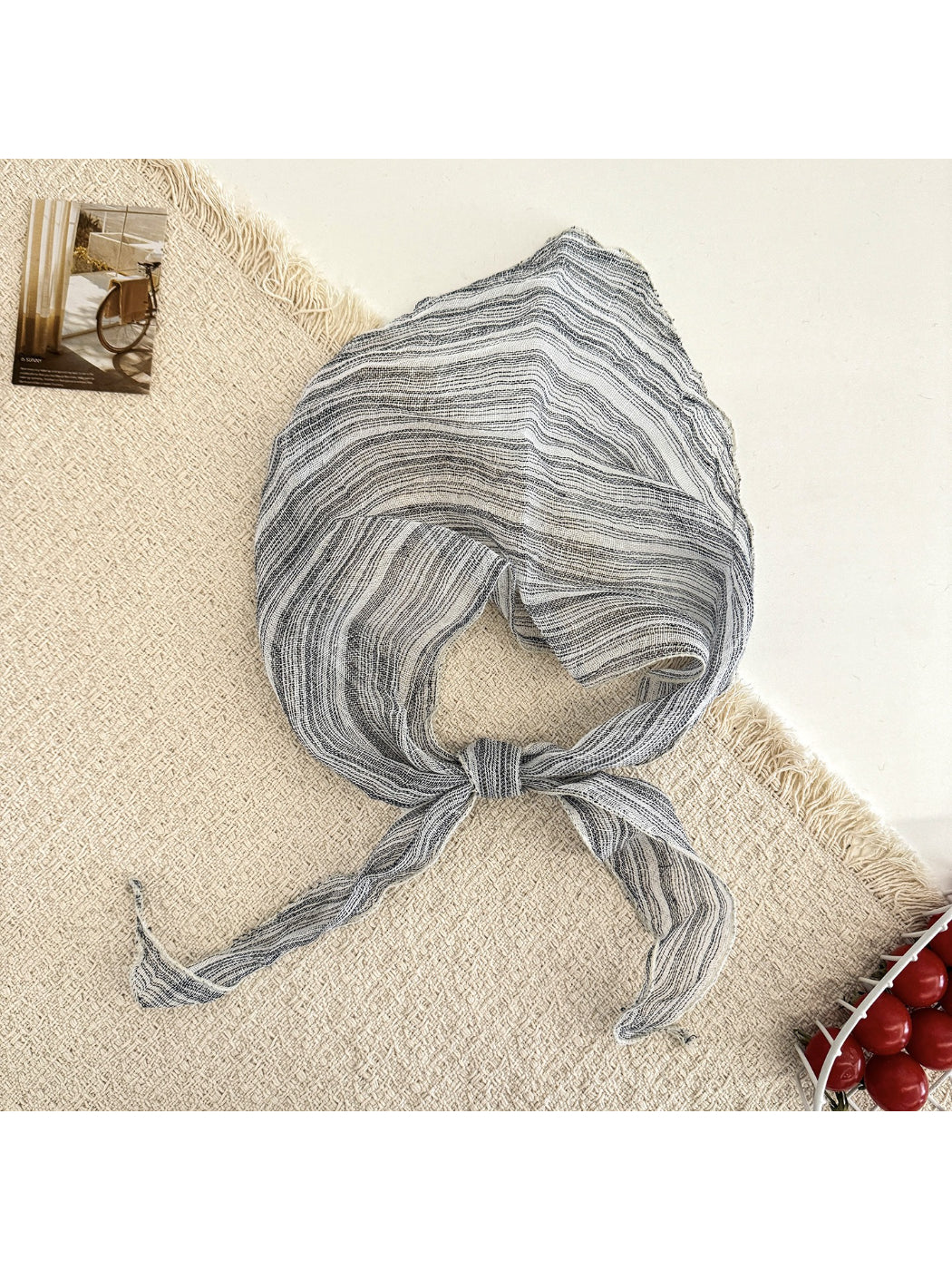Scarvii triangle scarf laid flat showing detailed plaid stripe design and triangular edges