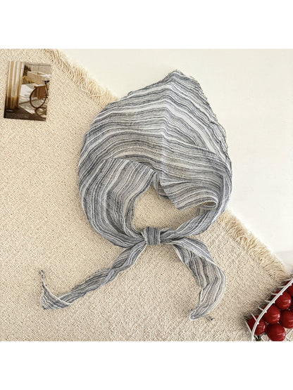 Scarvii triangle scarf laid flat showing detailed plaid stripe design and triangular edges